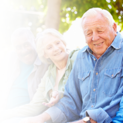 Four seniors sitting down and sharing a laugh outdoors at Northland Heights